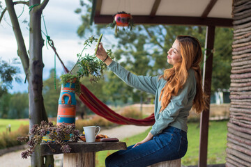 Poster - A pretty woman sitting outdoors and doing a selfie