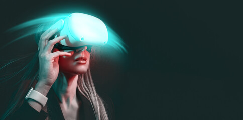 young woman with blond hair in a vr helmet looks around with surprise and delight