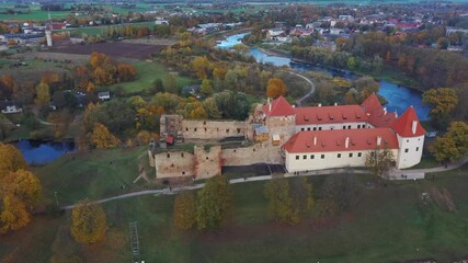 Wall Mural - Bauska Medieval Castle Ruins Complex and Park From Above Aerial Shot. Ruins of the Livonian Part of the Bauska Castle, Latvia in Autumn. Castle Was Built in the Middle of the 15th Century