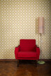 © Khorzhevska - Vintage room with old fashioned armchair, standart lamp, old fashioned wallpaper and weathered wooden parquet floor