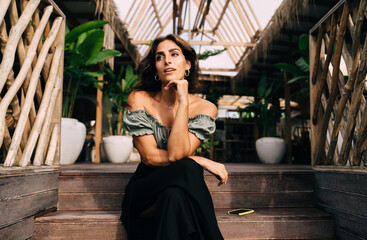 Thoughtful woman enjoying environment on terrace steps