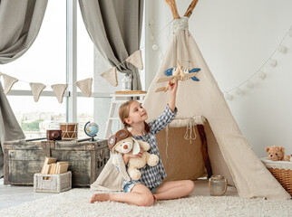 Wall Mural - Happy little girl flying wooden plane