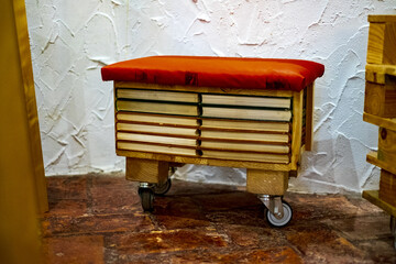 Wall Mural - A pallet ottoman with drawer on wheels with soft upholstery