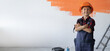 © Andrii Lysenko - boy dressed in overalls stands in the room with folded hands. Home renovation concept.