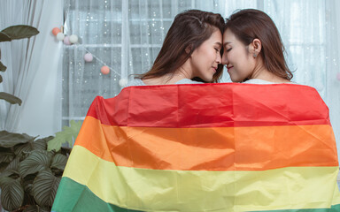 Portrait of two women with rainbow flag