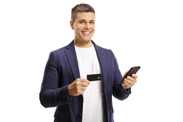 Poster - Young handsome man with a wide smile using a credit card for online payment with a mobile phone