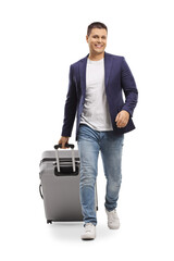 Canvas Print - Full length portrait of a man smiling and walking towards camera with a suitcase