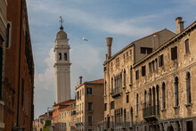 A Seagull Flies Past The Leaning Bell Tower Of The Campanile Of San Giorgio Dei Greci, In Venice, Italy. This Is One Of 10 Leaning Towers In The Whole Of Italy. 