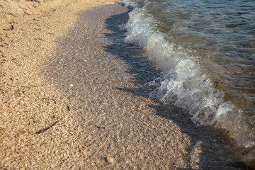 Waves of Adriatic sea flowing on the beach.