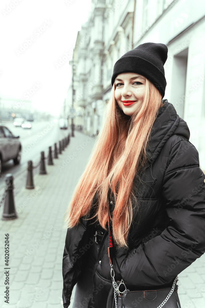 Portrait of charming beautiful girl with long hair on street of city ...