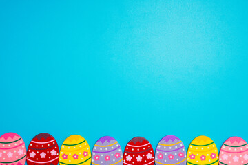 Wall Mural - Easter Eggs. Colorful Easter eggs on blue background with copy space