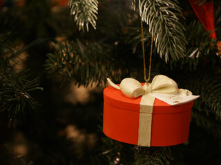 Red gift ornament on a Christmas Tree