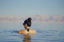 Brunette Girl Swimming In The Dead Sea In Israel