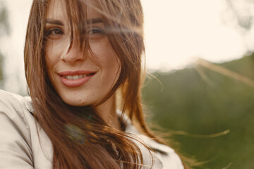 Girl walks. Woman in a brown coat. Brunette with a long hair.