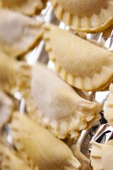 Sticker - A top view closeup of Polish pierogi placed on tinfoil ready to be cooked