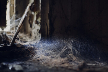 Sticker - A closeup of a pile of dust with spider web in the corner of an abandoned creepy room