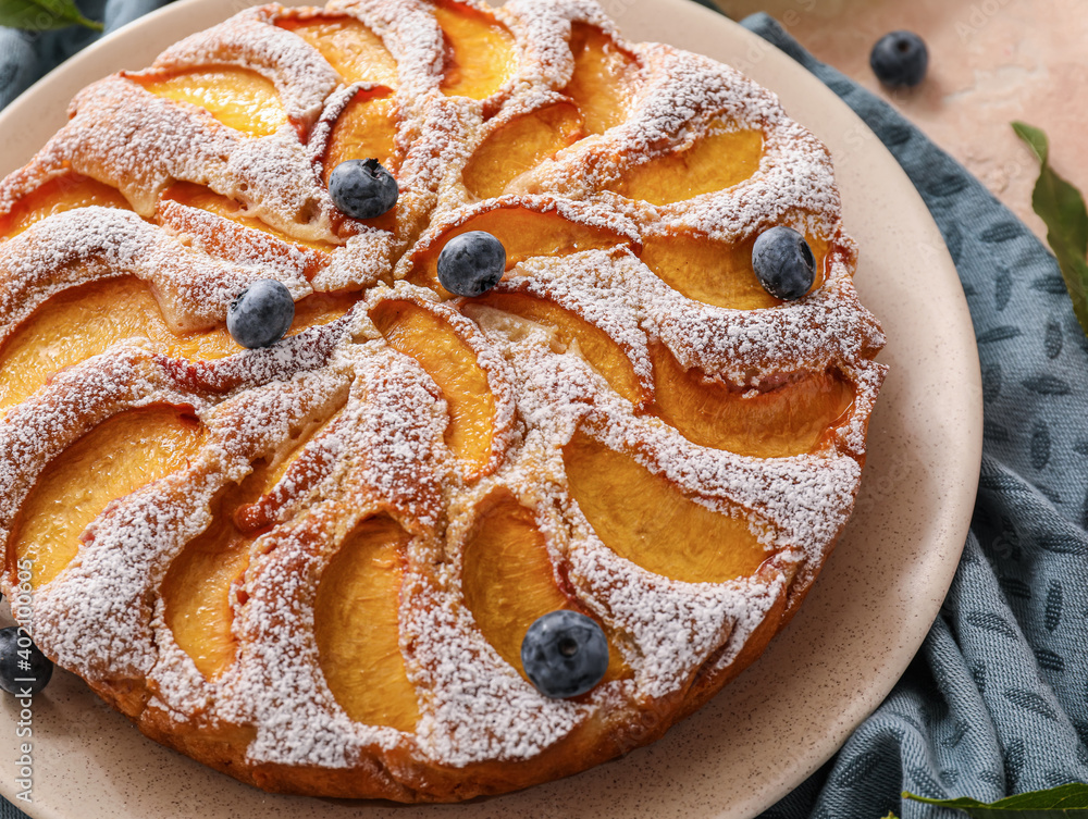 Plate with tasty peach pie, closeup