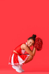 Wall Mural - Beautiful young cheerleader on color background