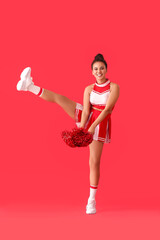 Wall Mural - Beautiful young cheerleader on color background