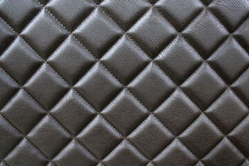  Stitched leather. Background of diamond-stitched leather. Close-up photos, selective focus.