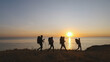 © realstock1 - The four travelers with backpacks walking on the seascape background