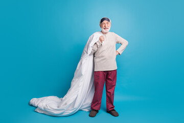 Poster - Full length photo portrait of excited old man in eye mask with blanket isolated on pastel blue colored background