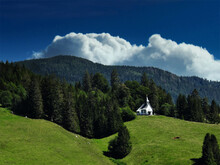 A Small White Chapel On A Meadow At The Edge Of The Forest In The Black Forest, Germany