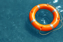 Orange Life Buoy Floating In Sea, Above View. Emergency Rescue Equipment
