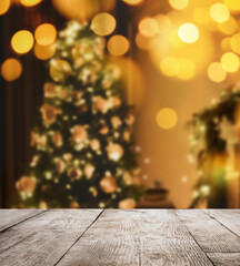 Empty wooden surface and blurred view of Christmas tree in room, space for text. Interior design