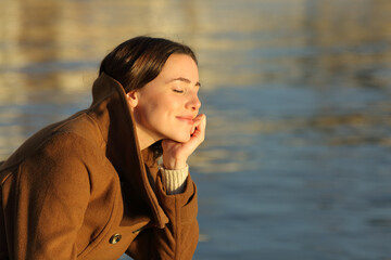 Wall Mural - Relaxed woman meditating on the beach in winter