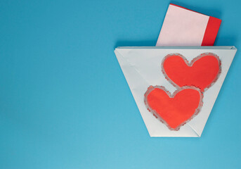 Love.  Greeting love card with red hearts on blue background.