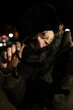 © Srdjan - Night close up portrait of old bearded homeless man with sunglasses standing on the street in the city in the cold winter time image with film grain