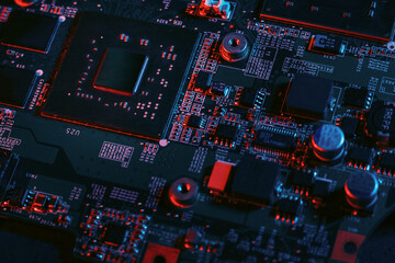 Hardware technology concept in neon light. Motherboard in blue-red light. Computer  component. Dark photo.Neon Colors.GPU processor. CPU