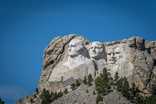 The Carved Busts Of George Washington, Thomas Jefferson, Theodore “Teddy” Roosevelt, And Abraham Lincoln At Mount Rushmore National Monument
