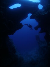 Scuba Divers Underwater Exploring Caves Blue Ocean Scenery