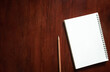 © Choat - Vintage picture tone. Blank notebook with brown pencil on wooden table