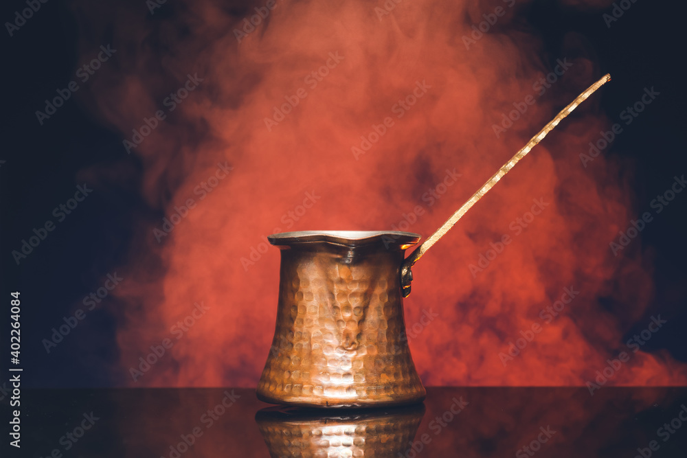 Cezve with coffee on dark background