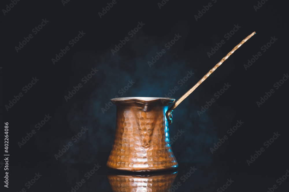 Cezve with coffee on dark background