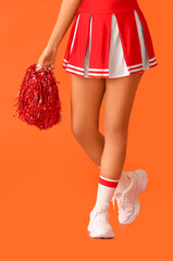 Wall Mural - Beautiful young cheerleader on color background