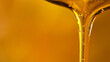 Leinwandbild Motiv Pouring oil or honey drop on golden background. Macro shot.