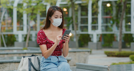 Canvas Print - Woman wear face mask and use of cellphone at outdoor