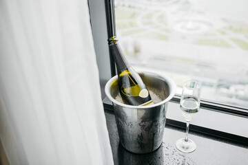 Expensive champagne is chilled in an ice bucket