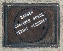 DANGER CONFINED SPACE  PERMIT  REQUIRED Warning Message On Manhole Cover.
