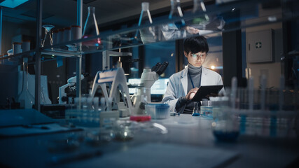Wall Mural - medical development laboratory: east asian scientist uses digital tablet computer, microscope, condu