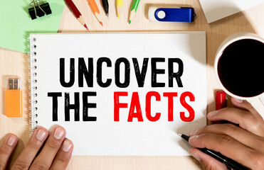 UNCOVER THE FACTS written on white page. Business