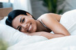 © nenetus - Smiling young woman with fresh skin in underwear having fun lying on bed while looking at camera at home.