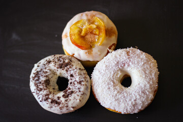 Three delicious Donuts on a black background