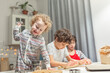 © Olga Gimaeva - happy family funny kids are preparing the dough, bake cookies in the kitchen