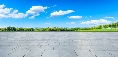 Empty square floor and green mountain background.