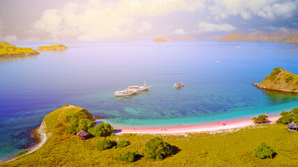 Wall Mural - Aerial view of a Pink beach in Flores, with a tourist and a yatch